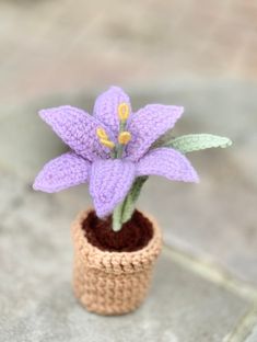 a crocheted purple flower in a small pot