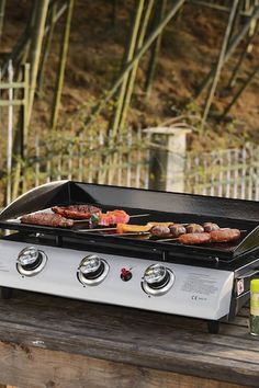 an outdoor grill with food cooking on it