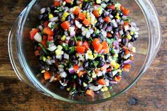 a glass bowl filled with black beans and carrots