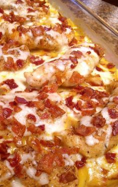 a casserole dish with chicken, cheese and bacon on it sitting on a counter