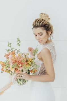 a beautiful woman holding a bouquet of flowers