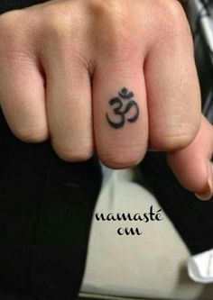 a person with a small tattoo on their finger