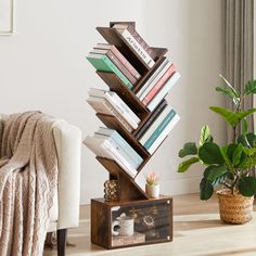 a stack of books on top of a wooden stand next to a couch and potted plant