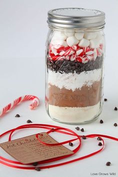 a jar filled with candy canes and marshmallows