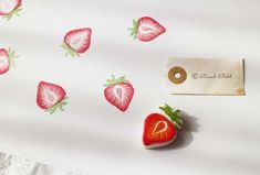 there is a strawberry on the table next to a tag