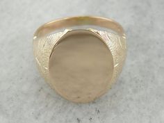 "What a perfect signet ring! We love the way that the undercarriage of this ring is hidden. The design creates the look of a weighty, heavy ring, but in fact this is an easy to wear piece, with an affordable price point thanks to the lattice work undercarriage! Market Square Jewelers works with one of the finest hand engravers in the northeast. With over 30 years of experience, our engraver hand carves lettering, monograms, crests, or patterns in period-specific styles. Choose from our many mono Antique Oval Signet Ring With Diamond Cut, Wedding Wide Band Signet Ring In Fine Jewelry Style, Polished Finish Wedding Signet Ring, Classic Oval Diamond Cut Signet Ring, Oval Signet Ring For Wedding With Polished Finish, Oval Signet Ring With Polished Finish For Wedding, Oval Wedding Signet Ring With Polished Finish, Fine Jewelry Oval Diamond Cut Signet Ring, Heirloom Signet Ring With Diamond Cut