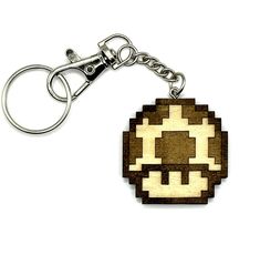 a wooden keychain with an image of a skull on it