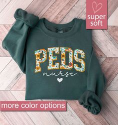 *We Are Not Affiliated With Any Other Company, Brand, Or Business. Indulge your pediatric nursing passion with our Floral Pediatric Nurse Sweatshirt, a cozy addition to your Peds Nurse Sweatshirts collection. This Pediatrics Sweater is not just a shirt; it's a heartfelt gift for nurses, perfect for nurse appreciation, graduation, or Nurses Week. Embrace the dedication of a picu nurse with our Picu Nurse Sweaters, crafted for comfort and style.  Celebrate the pediatric nurse in your life or treat Pediatric Cardiology, Peds Nurse Shirt, Pediatric Nursing Shirts, Nicu Nurse Sweater, Pacu Nurse Shirt, Pediatric Nurse Christmas Shirts, Sweatshirts Collection, Peds Nurse, Gifts For Nurses