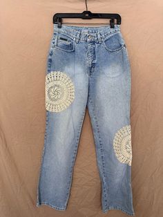 a pair of blue jeans with white patches on them