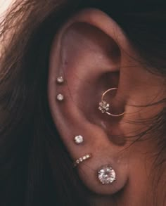 a woman with three different piercings on her ear