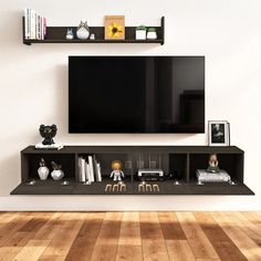 a flat screen tv mounted to the side of a wall next to a wooden floor