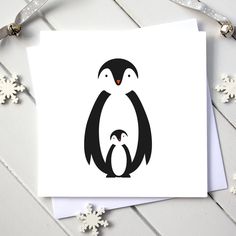 a card with an image of a penguin and its baby