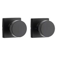 two black square knobs on the wall