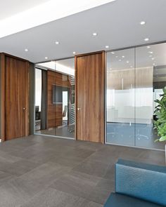 an empty office with wooden doors and glass walls