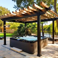 a hot tub sitting under a pergolated roof next to a lush green park