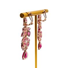 Long earrings can add a touch of elegance and glamour to any outfit, especially when dressing up for a night out. These beautiful fuchsia earrings are a perfect example of how accessories can enhance your overall look. The bold color of these earrings will make them stand out and draw attention to your face, while the length will add a sense of drama and sophistication. When wearing long earrings, it's important to keep the rest of your jewelry minimal so that the earrings can be the star of the Luxury Drop Linear Earrings For Party, Luxury Linear Drop Earrings For Party, Luxury Ruby Earrings For Evening, Pink Fine Jewelry Earrings For Party, Luxury Linear Earrings For Party, Luxury Pink Drop Earrings, Luxury Red Earrings For Party, Luxury Pink Dangle Earrings, Luxury Red Party Earrings