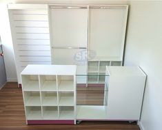 an empty room with white shelves and sliding doors