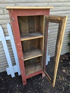 an old bookcase is painted red and white