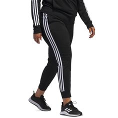 Keep active in these fitted Women's Essentials Warm-Up Slim Tapered 3-Stripes Track Pants from adidas, designed for zero distractions with a close, tapered fit that stays securely in place. The elastic waist features a convenient drawcord to customize coverage and comfort, while front pockets stash music players or cash. Breathable polyester fabrication keeps you cool whether climbing stairs or dropping low into squats, with flatlock seams preventing chafing. Subtle 3-Stripes branding adds style to this versatile workout wardrobe essential. Adidas Gym Pants With Three Stripes, Adidas Sweatpants With Three Stripes For Workout, Adidas Workout Joggers With Three Stripes, Adidas Joggers With Three Stripes For Workout, Adidas Three Stripes Joggers For Workout, Sportswear Joggers With Three Stripes For Workout, Athleisure Sweatpants With Three Stripes For Gym, Stretch Sweatpants With Side Stripes For Jogging, Adidas Moisture-wicking Sweatpants For Jogging