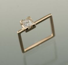 a diamond ring sitting on top of a table