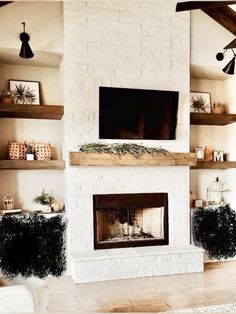 a living room filled with furniture and a flat screen tv mounted above a fire place