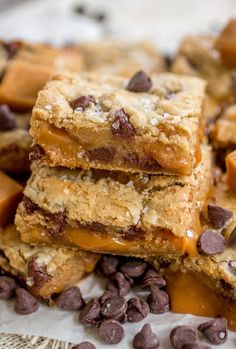 chocolate chip cookie bars stacked on top of each other with caramel and chocolate chips