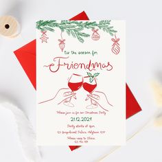 two glasses of wine are being toasted in front of an ornament on the card