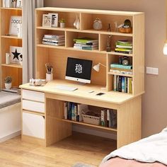 a wooden desk with a computer on top of it next to a book shelf filled with books