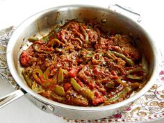 a pot filled with meat and vegetables on top of a table