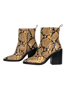 Elevate your safari chic style -- literally! You'll turn heads in these these striking boots from Tory Burch! Made with a sleek snakeskin embossed design and bold chunky heel, these bad boys are perfect for bohemian babes and party princesses alike! Pair with a maxi dress and chunky headband for a 70's-inspired look or hit the club in style with your favorite LBD and bouncy curls. No matter how you rock these beauties, you're sure to be fierce! Size 9.5 Leather upper with snakeskin embossed desi Fall Snake Print Ankle Boots, Leather Boots With Snake Print For Spring, Fall Leather Heeled Boots With Snake Print, Leather Heeled Boots With Snake Print For Fall, Fall Snake Print Round Toe Heeled Boots, Fall Round Toe Heeled Boots With Snake Print, Fall Snake Print Heeled Boots With Round Toe, Fall Season Snake Print Heeled Boots With Round Toe, Snake Print Heeled Boots With Round Toe For Fall