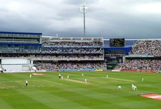 a baseball game is being played on a cloudy day