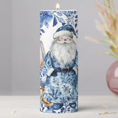 This unique christmas candle features a beautiful Chinoiserie-inspired blue and white floral wreath, accented with Santa Claus, sleigh and Christmas gifts. Personalize it easily and quickly by clicking the Edit Using Design Tool button. (c) The Happy Cat Studio Chinoiserie And Tartan Christmas, White Floral Wreath, French Chinoiserie, Santa Claus Sleigh, Blue Bathroom Accessories, Stationery Gifts, Chinoiserie Christmas, Chinoiserie Blue, Floral Christmas