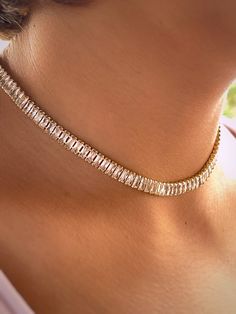 "\"18k Gold Plated Brass Tennis Choker with Cubic Zirconia, 15-3/4 inch (40 cm)\" Description: Elevate your accessory game with our exquisite tennis choker, crafted from high-quality brass and lavishly plated in 18k gold. This stunning piece is adorned with brilliantly sparkling cubic zirconia, set in a classic tennis style that wraps elegantly around the neck. At a length of 15-3/4 inches (40 cm), this choker is designed to offer a snug yet comfortable fit, making it an ideal choice for both everyday elegance and special occasions. The harmonious blend of the cubic zirconia's sparkle with the warm hue of the gold plating creates a sophisticated and timeless look. This tennis choker is not just a piece of jewelry; it's an expression of refined taste and luxury. Whether you're looking to ad Luxury Gold Plated Timeless Diamond Necklace, Luxury Yellow Gold Party Choker, Luxury Gold Tennis Necklace With Prong Setting, Luxury Round Yellow Gold Tennis Necklace, Gold Crystal Choker With Clavicle Chain, Gold Crystal Tennis Necklace For Wedding, Gold Cubic Zirconia Tennis Necklace For Party, Gold Crystal Tennis Necklace For Party, Silver Tennis Necklace Choker For Party