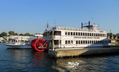 two paddle boats are docked in the water next to each other on a sunny day