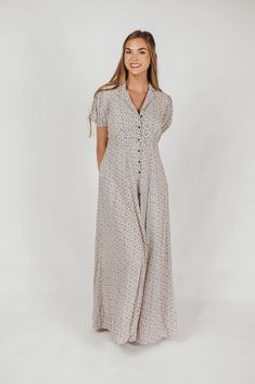 The Mariah Maxi Dress is a must-have for your cottagecore collection! This beautifully feminine dress features a collared V-neckline and a full front button placket; its dainty ditsy floral print is sweet and charming, perfect for dressing up for special occasions or wearing around the house. FIT: Runs a bit large on bust MATERIAL: Viscose. GARMENT DETAILS: Ditsy floral maxi dress with collared V-neckline, short sleeves with elasticized cuffs, and full front button placket. SIZE GUIDE: XS (0-2) / S (2-4) / M (6-8) / L (10-12) / XL (14-16) MODEL DETAILS: Mackenzie - Size S Heather - Size S Molly - Size XL Our Brunette Misses Model Our Blonde Misses Model Our Blonde Curve Model Bust 34" 34" 37" Waist 27.5" 27.5" 32" Hips 40.5" 37.5" 47" Height 5'7" 5'7" 5'7" Curve Model, Ditsy Floral Print, Fashion Aesthetics, Nursing Friendly, Peasant Style, Classic Wardrobe, Feminine Dress, Button Dress, Ditsy Floral