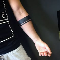 a person with a wristband on their arm and one hand in the other direction