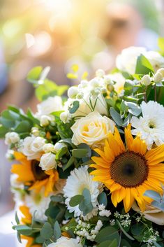 a bouquet of sunflowers and white roses