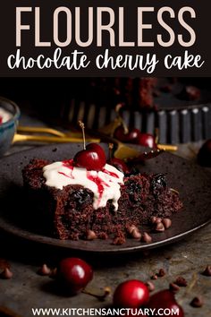 a piece of chocolate cherry cake on a black plate with cherries and whipped cream