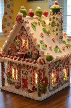 a gingerbread house is decorated with candy canes and candies