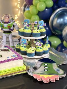 toy story birthday cake and cupcakes with buzz lightyear figures on top for decoration