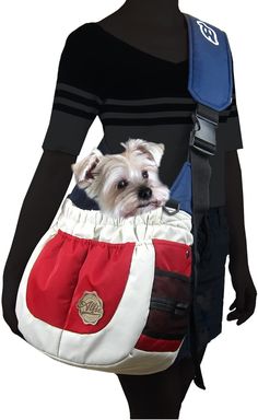 a small white dog in a red and blue bag on a mannequin's head