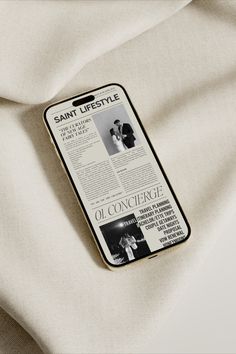 a cell phone case sitting on top of a white sheet covered in text and pictures