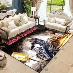 a living room with couches, chairs and a rug on the floor that has an image of a biker riding a motorcycle