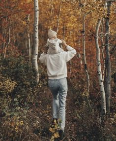 a person walking through the woods in autumn