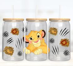 three glass jars with lion designs on them