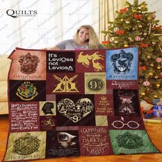 a woman holding up a harry potter quilt in front of a christmas tree with hog potters on it