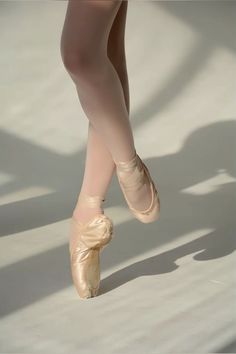 a ballerina's feet and ballet shoes in the sunlight