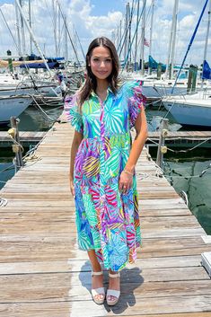 This multicolor printed dress features a collared neckline, smock detailed shoulders, frilled short sleeves, front button-up closure, side pockets, tiered, lined, and midi length. 50% Cotton 50% Rayon Hand Wash Cold. Do Not Wring Or Twist. Non Chlorine Bleach Only. Hang Dry. Low Iron As Needed. May Be Dry Cleaned. Madison is 5’8“ wearing a size Small.Model measurements:Bust: 32 in.Waist: 24 in.Hip: 34 In. Casual Multicolor Tropical Print Midi Dress, Casual Multicolor Midi Dress With Tropical Print, Casual Short Sleeve Midi Dress With Vibrant Print, Casual Multicolor Maxi Dress With Ruffles, Multicolor Ruffle Sleeve Dress For Vacation, Casual Midi Dress With Ruffle Sleeves For Vacation, Colorful Ruffled Vacation Dresses, Colorful Ruffled Dresses For Vacation, Casual Short Sleeve Multicolor Midi Dress