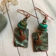 An organic, rustic copper patina charm with folds. They're free form, making them a fabulous one of a kind pair. The copper Star is a unique charm,  completing the earthy feel. The wonderful blues and greens in the patina charms are perfect with the turquoise. Earrings measure 1-3/4 inches long. Artsy Green Patina Jewelry, Rustic Green Jewelry With Patina, Blues And Greens, Copper Patina, True North, Turquoise Earrings, Unique Charms, Minneapolis, Jewelry Earrings Dangle