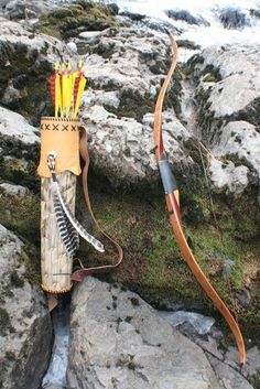 an arrow and bow sitting on some rocks